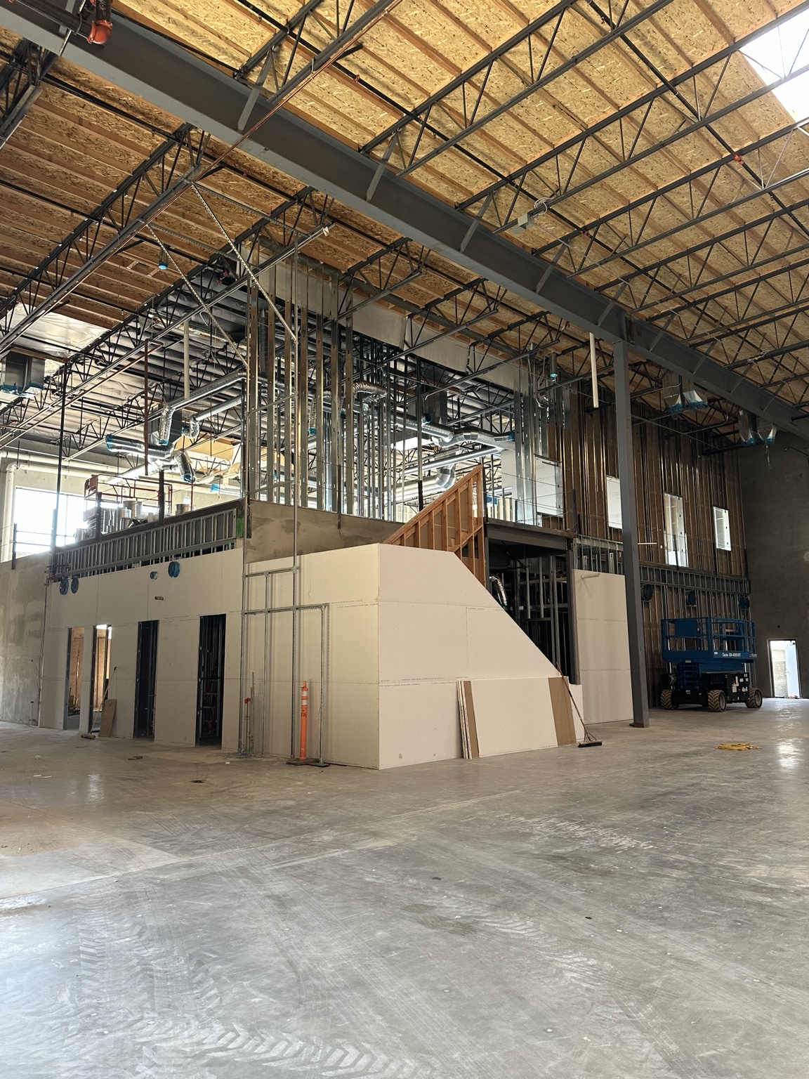 Overall commercial interior buildout with framing and drywall in progress